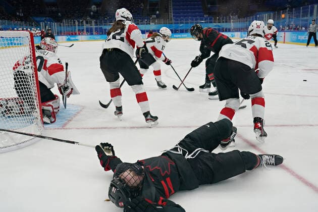 Canadian forward Sarah Fillier 10, is knocked down on the ice during play at the Swiss net in group A of women s Ice hockey, Eishockey at the National Indoor Stadium in the Winter Olympics in Beijing on Thursday, February 3, 2022. Canada dominated the game winning 12-1.  OLY20220203007 RICHARDxELLIS