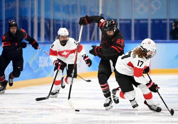(220203) -- BEIJING, Feb. 3, 2022 -- Marie-Philip Poulin (2nd R) of Canada vies with Lara Christen (1st R) of Switzerland during the women s Ice hockey, Eishockey preliminary round Group A match between Canada and Switzerland at National Indoor Stadium in Beijing, China, Feb. 3, 2022. ) (BEIJING2022)CHINA-BEIJING-OLYMPIC Winter games, Winterspiele,Spiele, Summer games ICE HOCKEY-WOMEN S PRELIMINARY?(CN) LixZiheng 