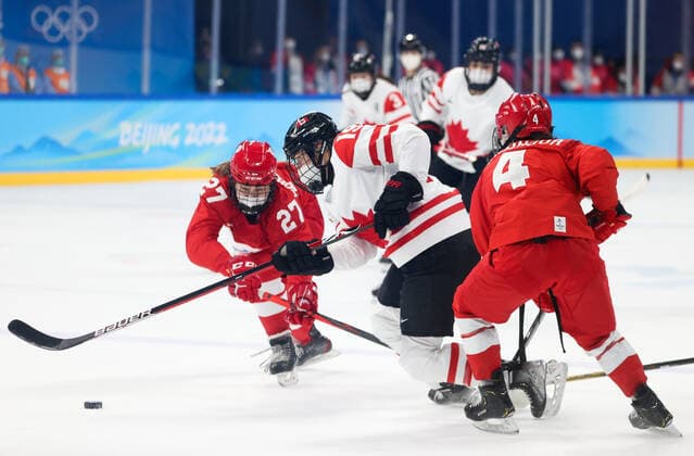 BEIJING, CHINA - FEBRUARY 7, 2022: Veronika Korzhakova of the ROC Team, Brianne Jenner of Canada and Yulia Smirnova (L-R) of the ROC Team fight for the puck in their women s Group A Ice hockey, Eishockey match at the 2022 Winter Olympic Games, Olympische Spiele, Olympia, OS at the Wukesong Sports Centre. Anton Novoderezhkin TASS  TS121AFC