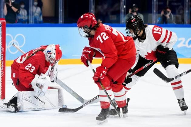 China Olympics 2022 Ice hockey, Eishockey Women ROC - Canada 8106798 07.02.2022 Russian Olympic Committee s Anna Savonina and Canada s Brianne Jenner struggle for a puck in the ice hockey women s preliminary round group A match between the Russian Olympic Committee s team and Canada during the Beijing 2022 Winter Olympic Games, Olympische Spiele, Olympia, OS at Wukesong Sports Centre in Beijing, China. Russian Olympic Committee s goaltender Daria Gredzen, is at left. Vladimir Astapkovich Sputnik Beijing China  Copyright: xVladimirxAstapkovichx