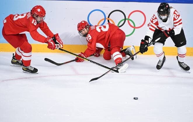 China Olympics 2022 Ice hockey, Eishockey Women ROC - Canada 8106831 07.02.2022 From left, Russian Olympic Committee s Nina Pirogova, Russian Olympic Committee s Alexandra Vafina and Canada s Natalie Spooner struggle for a puck in the ice hockey women s preliminary round group A match between the Russian Olympic Committee s team and Canada during the Beijing 2022 Winter Olympic Games, Olympische Spiele, Olympia, OS at Wukesong Sports Centre in Beijing, China. Vladimir Astapkovich Sputnik Beijing China  Copyright: xVladimirxAstapkovichx