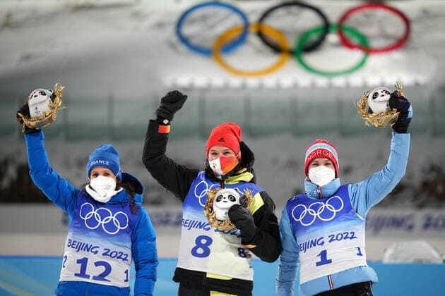 China Olympics 2022 Biathlon Women 8106981 07.02.2022 From left, silver medalist France s Anais Chevalier-Bouchet, gold medalist Germany s Denise Herrmann and bronze medalist Norway s Marte Olsbu Roeiseland celebrate on the podium during the flower ceremony for the biathlon women s 15 km individual competition during the Beijing 2022 Winter Olympic Games, Olympische Spiele, Olympia, OS at National Biathlon Centre in Zhangjiakou, China. Ramil Sitdikov Sputnik Zhangjiakou China  Copyright: xRamilxSitdikovx