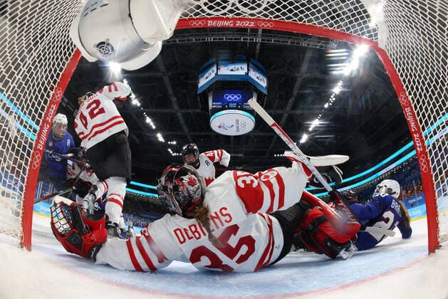 (220208) -- BEIJING, Feb. 8, 2022 -- Goalkeeper Ann-Renee Desbiens (front) of Canada tries to make a save during the Ice hockey, Eishockey women s preliminary round group A match between Canada and the United States at Wukesong Sports Centre in Beijing, capital of China, Feb. 8, 2022. Song Yanhua) (BEIJING2022)CHINA-BEIJING-OLYMPIC Winter games, Winterspiele,Spiele, Summer games ICE HOCKEY-WOMEN S PRELIMINARY-CANADA VS U.S. (CN) RemotexCamera 