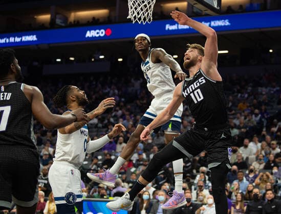 February 9, 2022, Sacramento, CA, USA: Sacramento Kings center Domantas Sabonis (13) reacts scoring a basket defended by Minnesota Timberwolves forward Jarred Vanderbilt (8) in the second quarter during a game at Golden 1 Center on Wednesday, Feb. 9, 2022 in Sacramento. Sacramento USA - ZUMAj89_ 20220209_zaf_j89_020 Copyright: xPaulxKitagakixJr.x