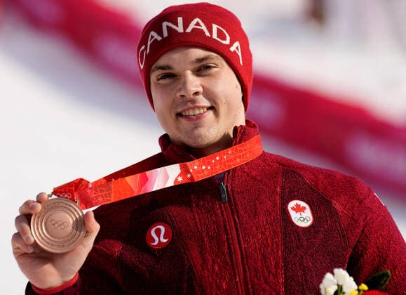James Crawford of Canada shows off his bronze medal after taking third in the men s Alpine Combined at the Winter Olympics in Beijing on Thursday February 10, 2022.  OLY20220210420 RICKxTxWILKING