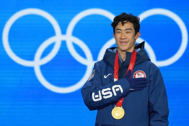Nathan Chen of the U.S. listens to his national anthem during the medals ceremony for the Men s Single Figure skating, Eiskunstlauf final at the Beijing 2022 Winter Olympics on Thursday, February 10, 2022. Chen won the gold medal, Yuma Kagiyama of Japan, the silver medal and Shoma Uno of Japan, the bronze medal.  OLY20220210307 PaulxHanna