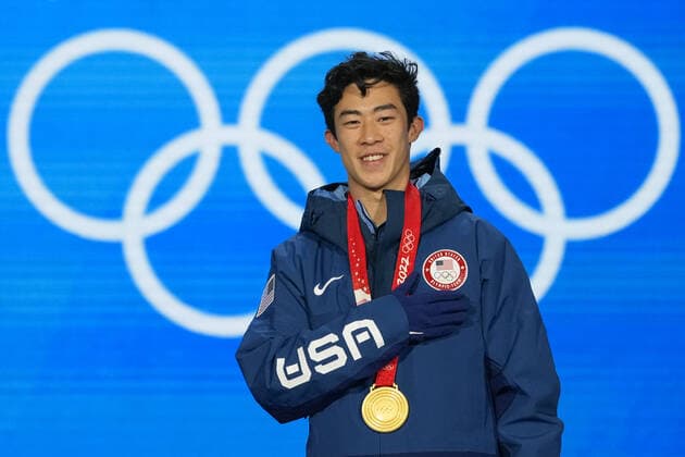 Nathan Chen of the U.S. listens to his national anthem during the medals ceremony for the Men s Single Figure skating, Eiskunstlauf final at the Beijing 2022 Winter Olympics on Thursday, February 10, 2022. Chen won the gold medal, Yuma Kagiyama of Japan, the silver medal and Shoma Uno of Japan, the bronze medal.  OLY20220210308 PaulxHanna