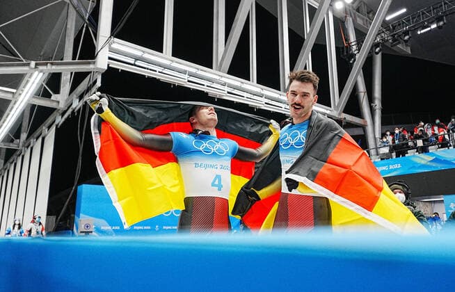 (220211) -- BEIJING, Feb. 11, 2022 -- Christopher Grotheer (L) and Axel Jungk of Germany celebrate after skeleton men heat of Beijing 2022 Winter Olympics at National Sliding Centre in Yanqing District, Beijing, capital of China, Feb. 11, 2022. ) (BEIJING2022)CHINA-BEIJING-OLYMPIC Winter games, Winterspiele,Spiele, Summer games SKELETON-MEN HEAT(CN) JiangxWenyao 