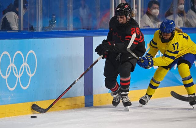 (220211) -- BEIJING, Feb. 11, 2022 -- Emily Clark (L) of Canada tries to control the puck during the Ice hockey, Eishockey women s play-off quarterfinal between Canada and Sweden at Wukesong Sports Centre in Beijing, capital of China, Feb. 11, 2022. ) (BEIJING2022)CHINA-BEIJING-ICE HOCKEY-WOMEN S PLAY-OFF-QUARTERFINAL-CAN VS SWE (CN) LixRan 