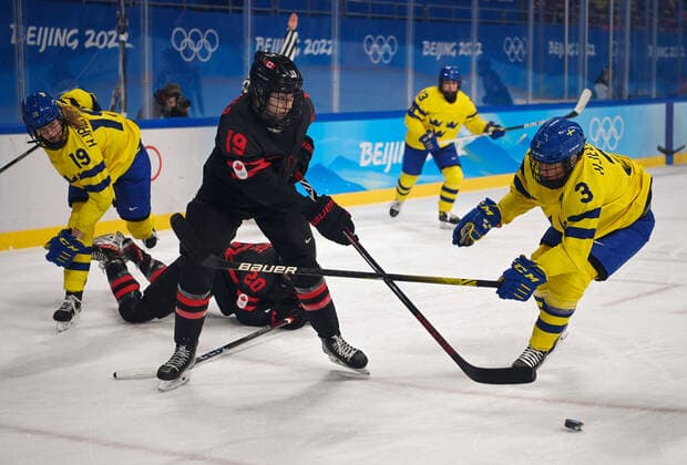 (220211) -- BEIJING, Feb. 11, 2022 -- Brianne Jenner (2nd L) of Canada passes the puck during the Ice hockey, Eishockey women s play-off quarterfinal between Canada and Sweden at Wukesong Sports Centre in Beijing, capital of China, Feb. 11, 2022. ) (BEIJING2022)CHINA-BEIJING-ICE HOCKEY-WOMEN S PLAY-OFF-QUARTERFINAL-CAN VS SWE (CN) LixRan 