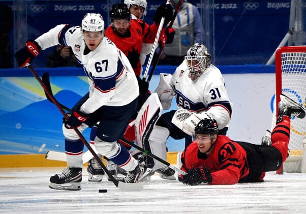 (220212) -- BEIJING, Feb. 12, 2022 -- Matt Knies (1st L) of the United States controls the puck during the Ice hockey, Eishockey men s preliminary round Group A match between the United States and Canada at National Indoor Stadium in Beijing, capital of China, Feb. 12, 2022. ) (BEIJING2022)CHINA-BEIJING-OLYMPIC Winter games, Winterspiele,Spiele, Summer games ICE HOCKEY-MEN S PRELIMINARY ROUND-USA VS CAN (CN) LixZiheng 
