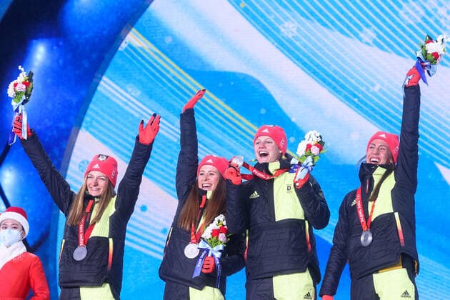ZHANGJIAKOU, CHINA â€“ FEBRUARY 12, 2022: Skiers Katherine Sauerbrey, Katharina Hennig, Victoria Carl, and Sofie Krehl (L-R) of Germany pose with their silver medals at a victory ceremony for the women s 4x5km cross-country skiing relay at the Beijing 2022 Winter Olympic Games, Olympische Spiele, Olympia, OS at the Zhangjiakou Medals Plaza. Stanislav Krasilnikov TASS  TS122B53