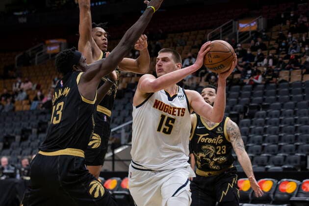 February 12, 2022, Toronto, ON, CAN: Denver Nuggets Nikola Jokic (15) looks to pass as Toronto Raptors Pascal Siakam, left, Scottie Barnes (centre left) and Fred VanVleet defend during second half NBA, Basketball Herren, USA basketball action in Toronto on Saturday, February 12, 2022. Nikola Jokic; Pascal Siakam; Scottie Barnes; Fred VanVleet  - ZUMAc35_ 20220212_zaf_c35_299 Copyright: xChrisxYoungx