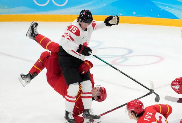 February 13, 2022, Beijing, ON, China: China defender Kailiaosi Jieke (7) gets upended over Canada forward Adam Tambellini (15) during first period men s Ice hockey, Eishockey action at the Beijing Olympic Winter games, Winterspiele,Spiele, Summer games in Beijing, Sunday, Feb. 13, 2022. Canada v. China Men s Olympic Ice Hockey - ZUMAc35_ 20220213_zaf_c35_025 Copyright: xRyanxRemiorzx