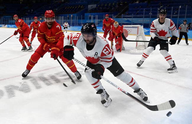 (220213) -- BEIJING, Feb. 13, 2022 -- David Desharnais of Canada controls the puck during the Ice hockey, Eishockey men s preliminary round Group A match between China and Canada at National Indoor Stadium in Beijing, capital of China, Feb. 13, 2022. ) (BEIJING2022)CHINA-BEIJING-OLYMPIC Winter games, Winterspiele,Spiele, Summer games ICE HOCKEY-MEN S PRELIMINARY-CHN VS CAN(CN) LiuxXiao 