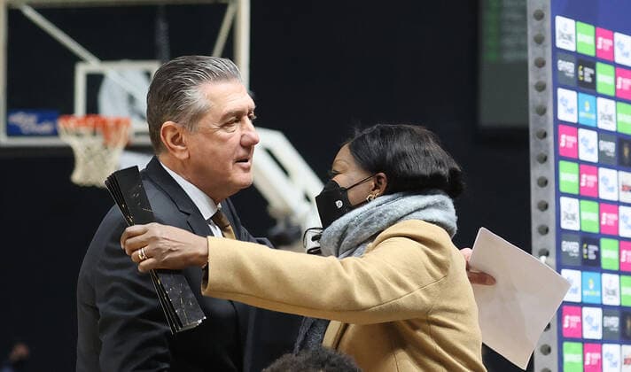 Co-coach Liviu Calin Braunschweig greets the mother of NBA player Denis Schroeder after the game