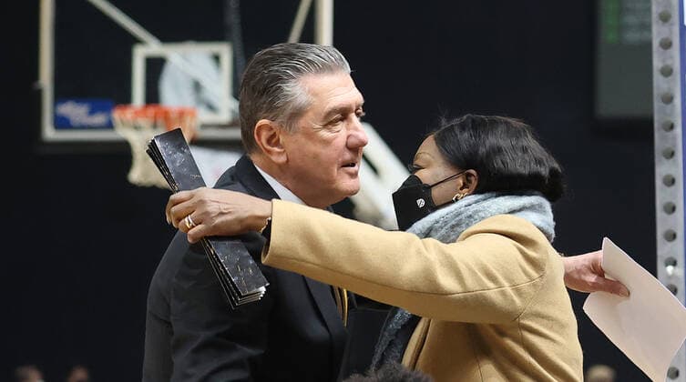 Co-coach Liviu Calin Braunschweig greets the mother of NBA player Denis Schroeder after the game