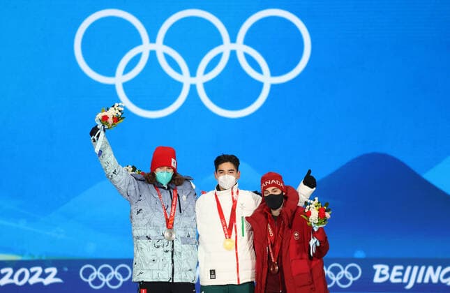 BEIJING, CHINA - FEBRUARY 14, 2022: Silver medalist, ROC athlete Konstantin Ivliyev, Gold medalist, Shaoang Liu of Hungary and Bronze medalist, Steven Dubois (L-R) of Canada attend an award ceremony for the men s 500m short track Speed skating, Eisschnelllauf event at the 2022 Winter Olympic Games, Olympische Spiele, Olympia, OS at the Medal Plaza. Anton Novoderezhkin TASS TS12316B