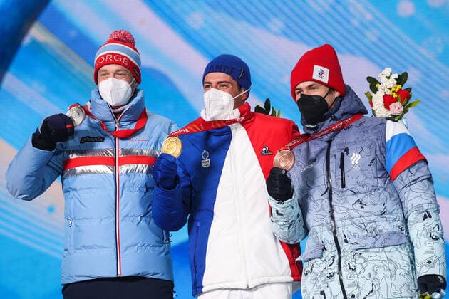 ZHANGJIAKOU, CHINA - FEBRUARY 14, 2022: Silver medalist, Tarjei Boe of Norway, Gold medalist, Quentin Fillon Maillet of France and Bronze medalist, ROC athlete Eduard Latypov (L-R) attend an award ceremony for the men s 12.5km biathlon pursuit event at the 2022 Winter Olympic Games, Olympische Spiele, Olympia, OS at the Medal Plaza. Sergei Bobylev TASS  TS123174