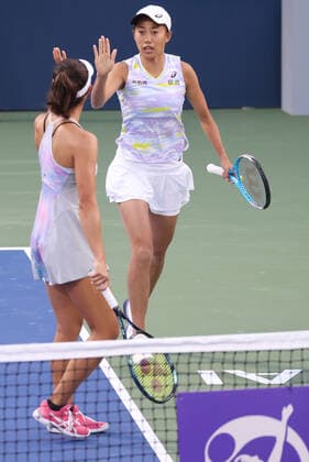 Zhang Shuai, CHN cap, full white , and Ena Shibahara, JPN, during first round doubles of 2022 Dubai Championships in Dubai, 14 02 2022