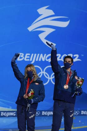 Bronze medallists Zachary Donohue and Madison Hubbell of the United States wave during the medals ceremony for the Figure skating, Eiskunstlauf Ice Dance competition at the Beijing 2022 Winter Olympics on Monday, February 14, 2022.  OLY20220214315 PaulxHanna