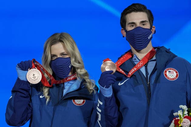 Bronze medallists Zachary Donohue and Madison Hubbell of the United States hold up their medals during the medals ceremony for the Figure skating, Eiskunstlauf Ice Dance competition at the Beijing 2022 Winter Olympics on Monday, February 14, 2022.  OLY20220214316 PaulxHanna