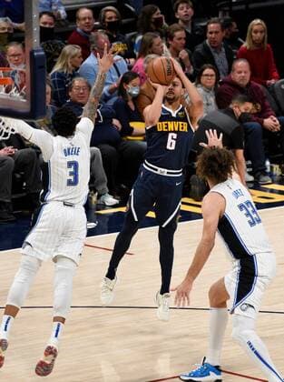 Denver Nuggets guard Bryn Forbes goes up for a shot against Orlando Magic forward Chuma Okeke (L) and center Robin Lopez (R), during a NBA, Basketball Herren, USA game at the Ball Arena in Denver, CO, USA, 14 February 2022. Orlando Magic at Denver Nuggets !ACHTUNG: NUR REDAKTIONELLE NUTZUNG!  Copyright: xToddxPiersonx AME5766 20220215-42e5a1136b74a3ba96c62438b5a4f3ef417da668