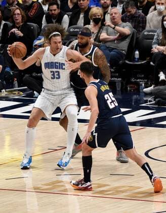 Orlando Magic center Robin Lopez (L) looks for an open man while fighting off Denver Nuggets center DeMarcus Cousins (C), during a NBA, Basketball Herren, USA game at the Ball Arena in Denver, CO, USA, 14 February 2022. Orlando Magic at Denver Nuggets !ACHTUNG: NUR REDAKTIONELLE NUTZUNG!  Copyright: xToddxPiersonx AME5769 20220215-51bdb5bbe5743a349f2ee807ca636bfbab4cb7a4