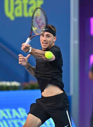 (220215) -- DOHA, Feb. 15, 2022 -- Alex Molcan of Slovakia returns the ball to Christopher O Connell of Australia during the first round of ATP, Tennis Herren Qatar Open tennis match in Doha, capital of Qatar, Feb. 14, 2022. (Photo by Xinhua) (SP)QATAR-DOHA-TENNIS-ATP QATAR OPEN Nikku 