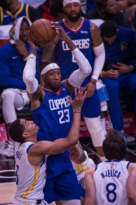 February 14, 2022, Los Angeles, California, USA: Robert Covington, 23 of the Los Angeles Clippers passes the ball as Jordan Poole 3 and Nemanja Bjelica 8 of the Golden State Warriors attempt to block him during their NBA, Basketball Herren, USA game on Monday February 14, 2022 at Crypto.com Arena in Los Angeles, California. Clippers defeat Warriors, 119-104. ARIANA RUIZ PI Los Angeles USA - ZUMAp124 20220214_zaa_p124_004 Copyright: xArianaxRuizx