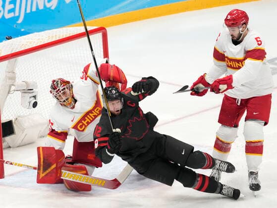 February 15, 2022, Beijing, China: Team Canada forward Eric Staal (12) falls in front of Team China goaltender jeremy Smith as defender Sipulaoer Ruian (5) looks on during first period men s qualification round hockey action at the Beijing Winter Olympics in Beijing, China, on Tuesday, Feb. 15, 2022. Canada News - February 15, 2022  - ZUMAc35_ 20220215_zaf_c35_108 Copyright: xRyanxRemiorzx