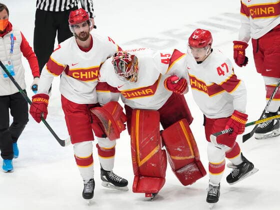 February 15, 2022, Beijing, China: Team China goaltender Jeremy Smith (45) is helped off the ice by teammates An Jian (47) and Jake Chelios (7) during first period men s qualification round hockey action against Canada at the Beijing Winter Olympics in Beijing, China, on Tuesday, Feb. 15, 2022. Canada News - February 15, 2022  - ZUMAc35_ 20220215_zaf_c35_116 Copyright: xRyanxRemiorzx