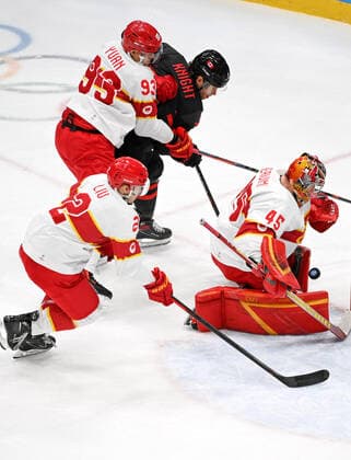 (220215) -- BEIJING, Feb. 15, 2022 -- Goalkeeper Shimisi Jieruimi (R) of China makes a save during the Ice hockey, Eishockey men s qualification play-off of Beijing 2022 Winter Olympics between Canada and China at Wukesong Sports Centre, in Beijing, capital of China, Feb. 15, 2022. ) (BEIJING2022)CHINA-BEIJING-OLYMPIC Winter games, Winterspiele,Spiele, Summer games ICE HOCKEY-MEN S QUALIFICATION PLAY-OFF-CAN VS CHN (CN) LixZiheng 