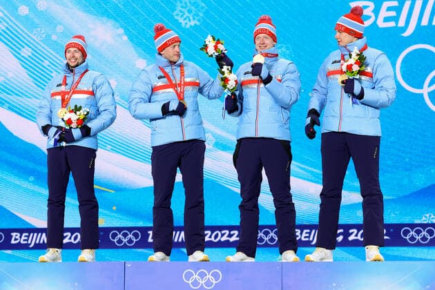 BEIJING 2022, Biathlon, 4x7,5km Staffel Männer, Siegerehrung ZHANGJIAKOU, CHINA - FEBRUARY 16, 2022: Athletes Sturla Holm Laegreid, Tarjei Bo, Johannes Bo and Vetle Sjastad Christiansen (L-R) of Norway celebrate their gold medals during the men s biathlon relay victory ceremony at the Medal Plaza as part of the 2022 Winter Olympic Games, Olympische Spiele, Olympia, OS Stanislav Krasilnikov TASS TS123935