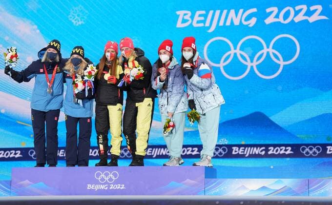 China Olympics 2022 Medal Ceremony 8118072 17.02.2022 From left, silver medalists Sweden s Maja Dahlqvist and Jonna Sundling, gold medalists Germany s Katharina Hennig and Victoria Carl and bronze medalists Russian Olympic Committee s Yulia Stupak and Natalia Nepryaeva celebrate on the podium during an award ceremony for the women s cross-country team sprint classic event during the Beijing 2022 Winter Olympic Games, Olympische Spiele, Olympia, OS at the Medals Plaza in Zhangjiakou, China. Pavel Bednyakov Sputnik Zhangjiakou China  Copyright: xPavelxBednyakovx