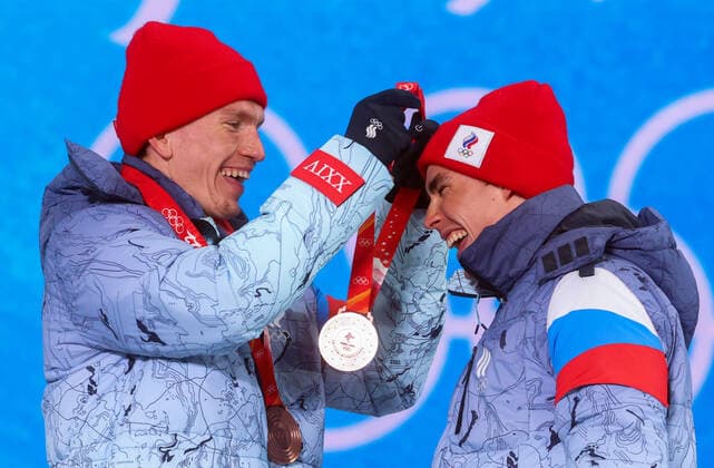 ZHANGJIAKOU, CHINA - FEBRUARY 17, 2022: Bronze medallists Alexander Bolshunov (L) and Alexander Terentyev of Team ROC are seen during the victory ceremony for the men s cross-country skiing team sprint classic, at the Medal Plaza, at the 2022 Winter Olympic Games, Olympische Spiele, Olympia, OS Stanislav Krasilnikov TASS  TS123CFA