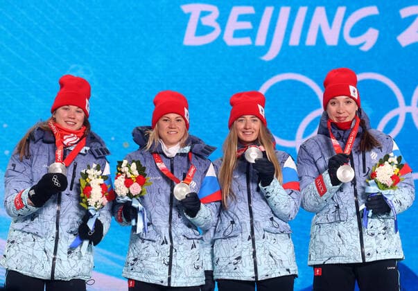 ZHANGJIAKOU, CHINA - FEBRUARY 17, 2022: Silver medallists Irina Kazakevich, Kristina Reztsova, Svetlana Mironova and Ulyana Nigmatullina of Team ROC (L-R) celebrate during the victory ceremony for the women s biathlon 4x7.5km relay, at the Medal Plaza, at the 2022 Winter Olympic Games, Olympische Spiele, Olympia, OS Stanislav Krasilnikov TASS  TS123D16