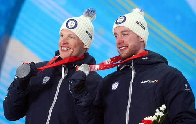 ZHANGJIAKOU, CHINA - FEBRUARY 17, 2022: Silver medallists Iivo Niskanen (L) and Joni Maki of Finland celebrate during the victory ceremony for the men s cross-country skiing team sprint classic, at the Medal Plaza, at the 2022 Winter Olympic Games, Olympische Spiele, Olympia, OS Stanislav Krasilnikov TASS  TS123D56