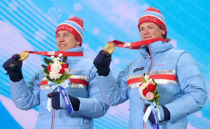 ZHANGJIAKOU, CHINA - FEBRUARY 17, 2022: Gold medal winners Erik Valnes and Johannes Hoesflot Klaebo of Norway celebrate during the victory ceremony for the men s cross-country skiing team sprint classic, at the Medal Plaza, at the 2022 Winter Olympic Games, Olympische Spiele, Olympia, OS Stanislav Krasilnikov TASS  TS123D57