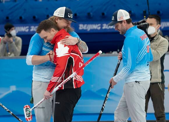 February 18, 2022, Beijing, China: CanadaöÄÃ s skip Brad Gushue gets a hug from USAöÄÃ s Matt Hamilton as USA skip John Shuster looks on after winning the bronze medal curling match Friday, February 18, 2022 at the 2022 Winter Olympics in Beijing. Brad Gushue, Matt Hamilton, John Shuster  - ZUMAc35_ 20220218_zaf_c35_048 Copyright: xRyanxRemiorzx
