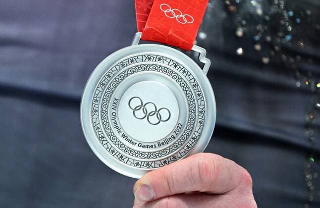 China Olympics 2022 Medal Ceremony 8120839 19.02.2022 Silver medalist Vladimir Morozov shows off his medal during the medal ceremony for the pairs Figure skating, Eiskunstlauf event during the Beijing 2022 Winter Olympic Games, Olympische Spiele, Olympia, OS at Capital Indoor Stadium in Beijing, China. Vladimir Astapkovich Sputnik Beijing China  Copyright: xVladimirxAstapkovichx