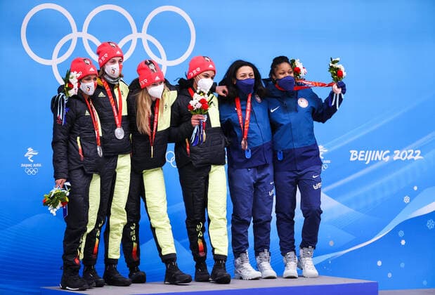 BEIJING, CHINA - FEBRUARY 19, 2022: Silver medalists Mariama Jamanka and Alexandra Burghardt of Germany, gold medalists Laura Nolte and Deborah Levi of Germany, bronze medalists Elana Meyers Taylor and Sylvia Hoffman of the USA (L-R) at a flower ceremony for the 2-woman bobsleigh at the 2022 Winter Olympic Games, Olympische Spiele, Olympia, OS at the Yanqing National Sliding Centre. Anton Novoderezhkin TASS  TS124673