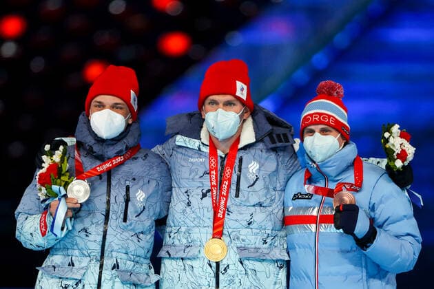 BEIJING, CHINA â€“ FEBRUARY 20, 2022: Silver medallist Ivan Yakimushkin of Team ROC, gold medallist Alexander Bolshunov of Team ROC, and bronze medallist Simen Hegstad Krueger (L-R) of Norway pose at a victory ceremony for the men s 30km cross-country skiing mass start race at the closing ceremony of the Beijing 2022 Winter Olympic Games, Olympische Spiele, Olympia, OS at the National Stadium (also known as the Bird s Nest). The men s 50km cross-country skiing mass start race has been shortened to 30km due to weather conditions. Valery Sharifulin TASS  TS124977