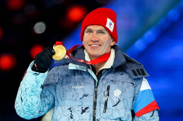 BEIJING, CHINA â€“ FEBRUARY 20, 2022: Gold medallist Alexander Bolshunov of Team ROC poses at a victory ceremony for the men s 30km cross-country skiing mass start race at the closing ceremony of the Beijing 2022 Winter Olympic Games, Olympische Spiele, Olympia, OS at the National Stadium (also known as the Bird s Nest). The men s 50km cross-country skiing mass start race has been shortened to 30km due to weather conditions. Valery Sharifulin TASS  TS12497C