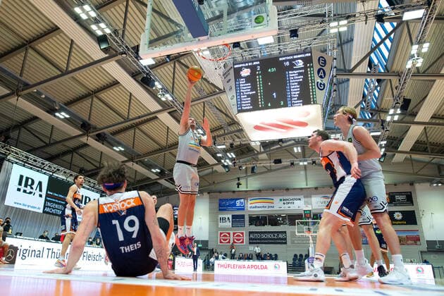 BARMER 2 Basketball Bundesliga ProA Season 2021 2022 Matchday 26 on 20 2 22 Medipolis SC Jena vs Rostock Seawolves center Stephan Haukohl Jena at the basket left on the floor Sid Marlon Theis Rostock Sparkassen Arena