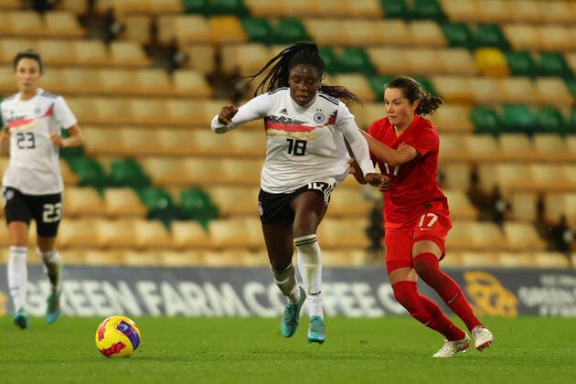 20th February 2022 ; Carrow Road, Norwich, Norforlk, England; Arnold Clark Womens International football Canada versus Germany: Nicole Anyomi of Germany is under pressure from Jessie Fleming of Canada  ActionPlus12366216 ShaunxBrooks