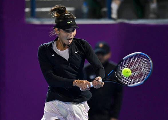 (220222) -- DOHA, Feb. 22, 2022 -- Jaqueline Cristian of Romania hits a return during the first round of WTA, Tennis Damen Qatar Open tennis tournament match against Elena Rybakina of Kazakistan at the Khalifa International Tennis Complex in Doha, capital of Qatar, on Feb. 21, 2022. (Photo by Xinhua) (SP)QATAR-DOHA-TENNIS-WTA QATAR OPEN Nikku 