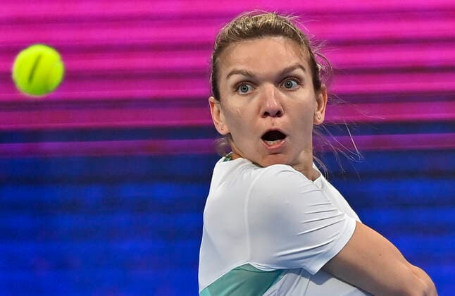 (220222) -- DOHA, Feb. 22, 2022 -- Simona Halep of Romania hits a return during the first round of WTA, Tennis Damen Qatar Open tennis tournament match against Caroline Garcia of France at the Khalifa International Tennis Complex in Doha, capital of Qatar, on Feb. 21, 2022. (Photo by Nikku Xinhua) (SP)QATAR-DOHA-TENNIS-WTA QATAR OPEN yangyuanyong 