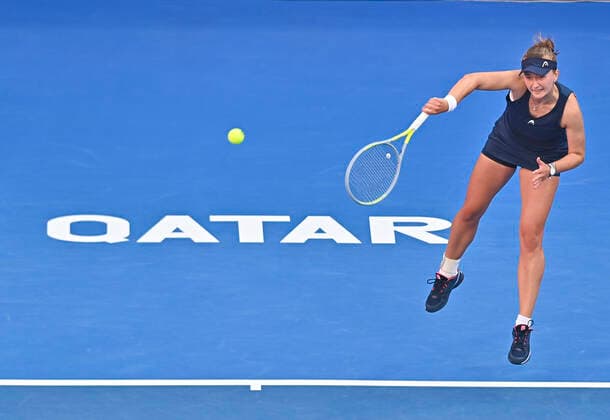 (220223) -- DOHA, Feb. 23, 2022 -- Barbora Krejcikova of Czech Republic serves during the second round of WTA, Tennis Damen Qatar Open tennis tournament match against Magda Linette of Poland at the Khalifa International Tennis Complex in Doha, capital of Qatar, on Feb. 22, 2022. (Photo by Nikku Xinhua) (SP)QATAR-DOHA-TENNIS-WTA QATAR OPEN-DAY 5 yangyuanyong 