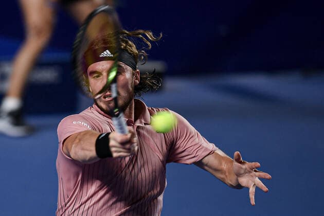 (220223) -- ACAPULCO, Feb. 23, 2022 -- Stefanos Tsitsipas of Greece hits a return during the men s singles first round match against Laslo Djere of Serbia at the 2022 ATP, Tennis Herren Mexican Open tennis tournament in Acapulco, Mexico, Feb. 22, 2022. ) (SP)MEXICO-ACAPULCO-TENNIS-ATP-MEXICAN OPEN-FIRST ROUND XinxYuewei 